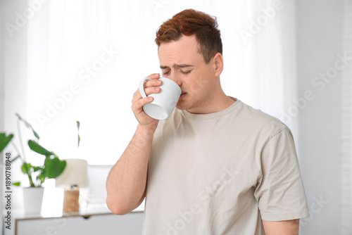 Young man drinking tea and ...