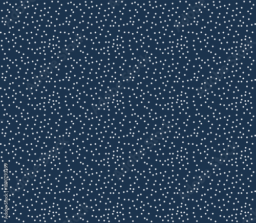 Seamless white polka dot pattern on dark blue background, falling snow or starry night sky texture. 
