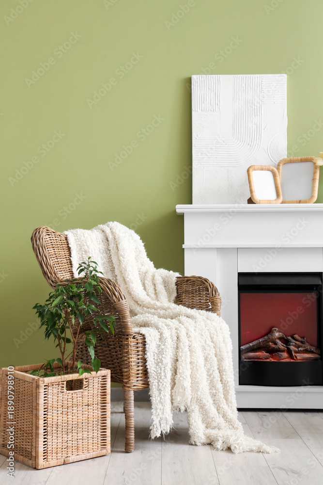 Obraz premium Interior of stylish living room with armchair, painting and blank frames on fireplace