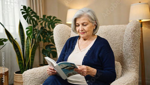 An older woman in a navy cardigan sits in a plush chair. She reads a wellness booklet. The lounge has indoor plants and soft, neutral colors, cozy atmosphere for reading