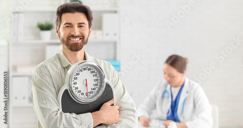 Young man with weight scales at nutritionist's office