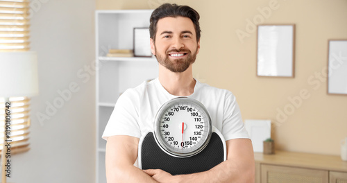 Young man with weight scale...
