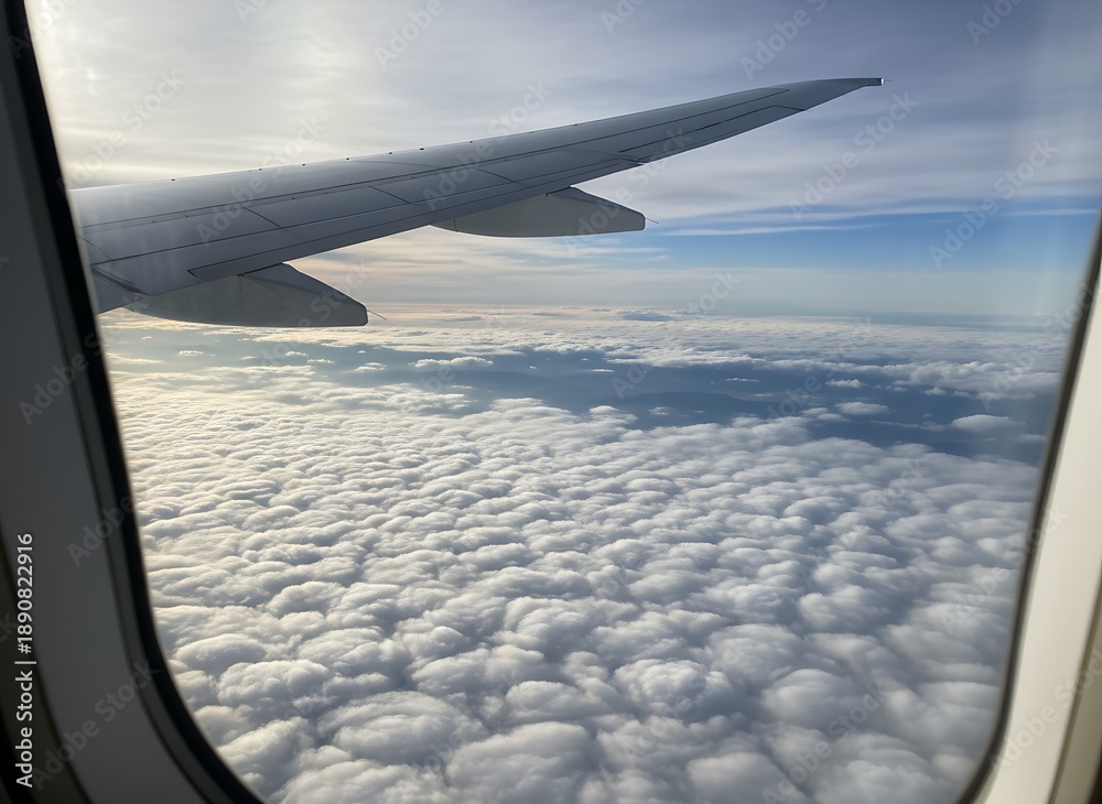 Obraz premium Aerial view of fluffy white clouds from an airplane window