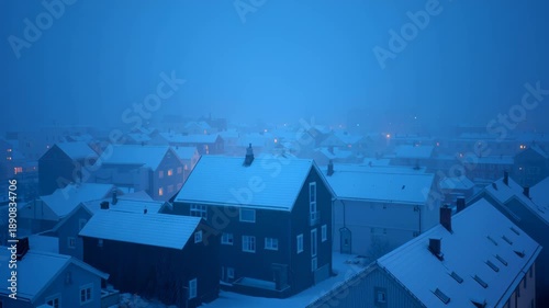 Snow-covered rooftops under a foggy winter sky illustrating danger and beauty with a sense of tranquility and forewarning