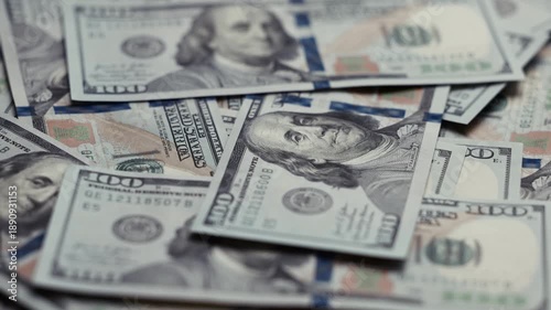 Close-up view of scattered US dollar banknotes showing detailed designs and textures, emphasizing the progression of wealth and financial abundance across the frames