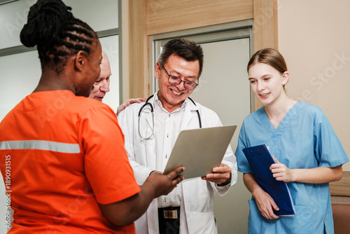 A diverse team of healthcare professionals collaborates on a medical report in a clinical environment. The scene highlights teamwork, trust, and shared expertise in patient care and health improvement