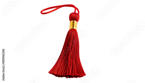 A single, isolated red tassel with a gold band and hanging loop, against a black background