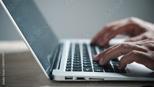Bild auf Leinwand Close-up of hands typing on a laptop keyboard