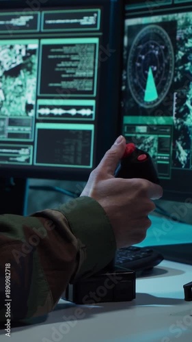 Soldier in a dimly lit military control room, intensely focused on multiple computer screens displaying crucial operational drone data.