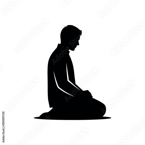 Silhouette of a man kneeling in prayer or contemplation.
