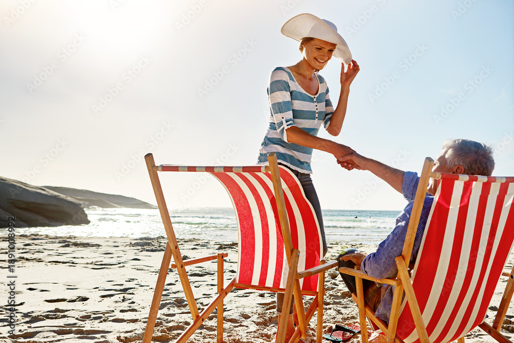 Fototapeta premium Holding hands, chairs and happy senior couple on beach for holiday, vacation and anniversary getaway. Travel, retirement and old man and woman by ocean, sea and sunset for bonding, love and relax