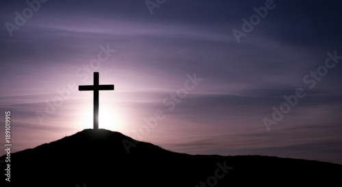 Dramatic silhouette of the christian cross standing on a hill, backlit by a somber purple sky, representing the spiritual sacrifice of good friday.