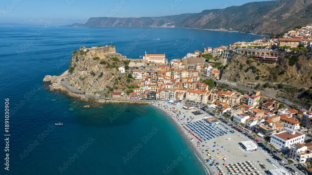 Fototapeta premium Aerial view of the historic center of the town of Scilla, in Calabria, Italy. Panorama of a beautiful village located on a promontory overlooking the Mediterranean Sea. In foreground it's the beach.