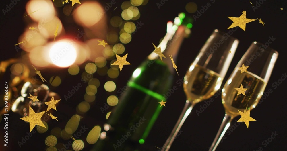 Fototapeta premium Showing two clear champagne flutes bubbly on party table with green bottle, gold stars, copy space