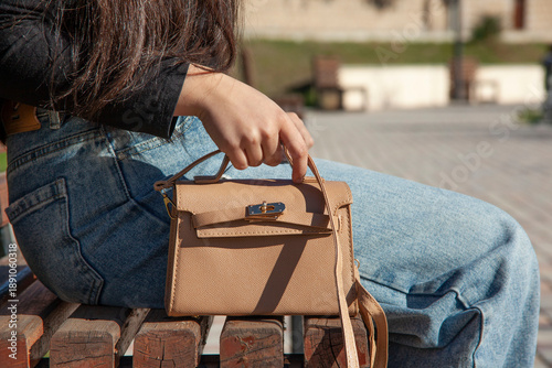 woman with stylish handbag on city street