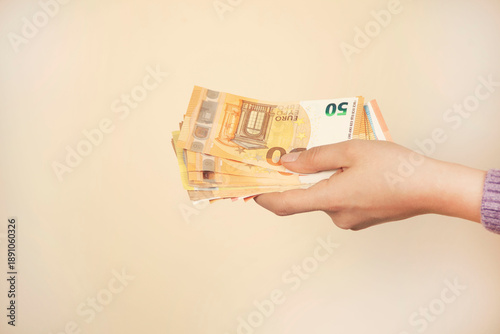 woman holding a euro banknotes in hand