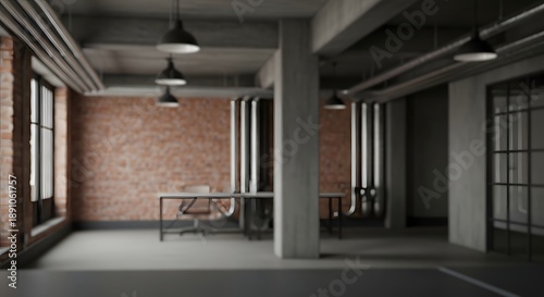 Interior view of a modern industrial office space with exposed brick walls, concrete columns, and large windows, showcasing a minimalist workspace with a desk and chairs