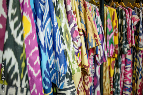 Canvastavla Traditional Uzbek ikat robes and dresses hanging on a rack