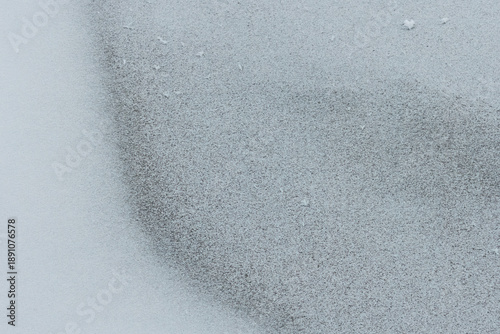 Frost-covered surface with soft gradient of snow
