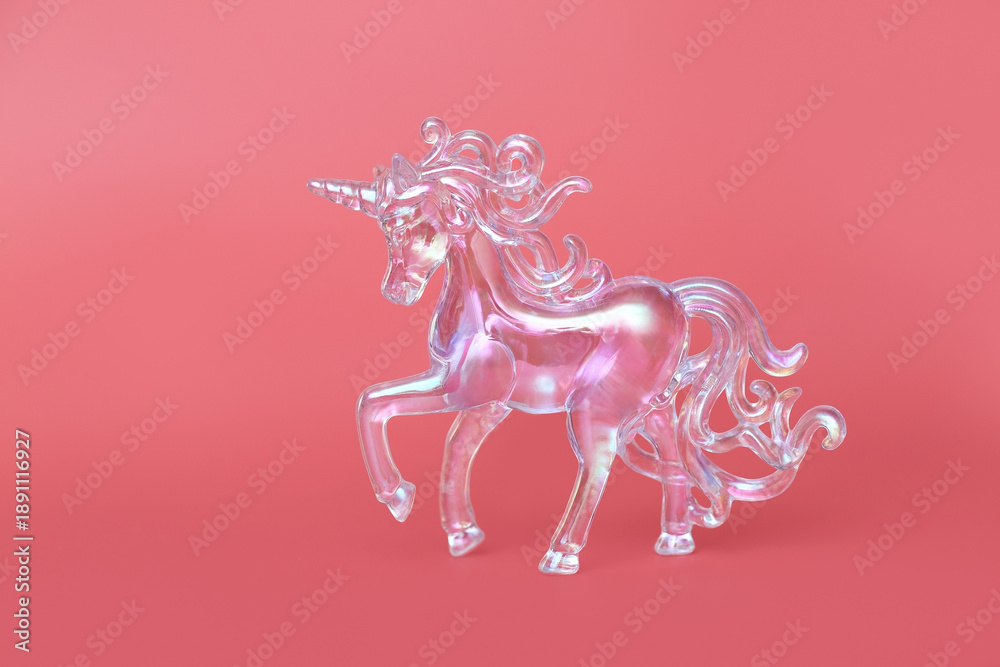 Obraz premium Fantasy horse made of transparent acrylic glass. A close-up of the subject. A New Year's toy. A pendant for the interior. Crystal unicorn on pink background.