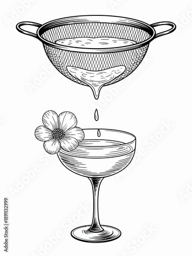 Preparing a refreshing cocktail being strained into an elegant coupe glass with a flower