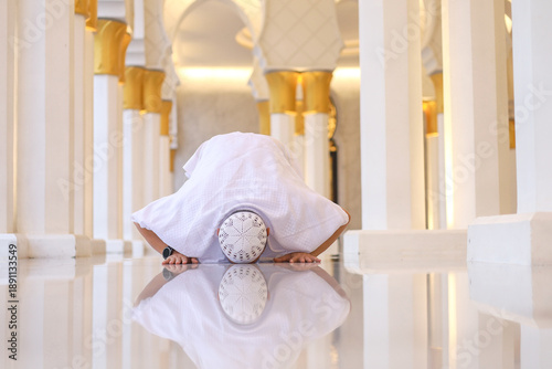 Vászonkép Front View Of Asian Muslim Man Performing Sujud Prostration With Reflection