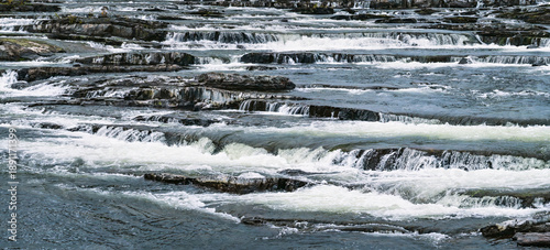 Photos Trappstegsforsen waterfall creating stepped cascades over rocky riverbed