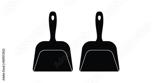 Two black dustpans displayed side by side a striking silhouette