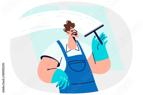 Man window cleaner cleans glass, polishing surface and removing traces of streaks and stains
