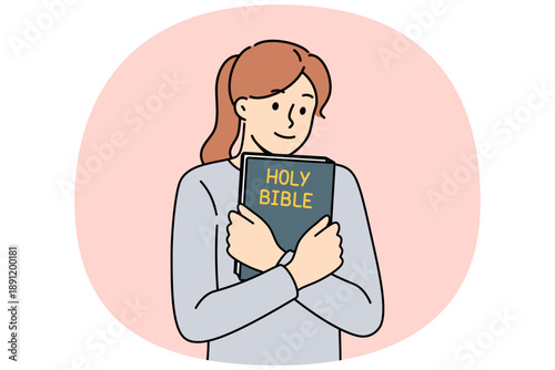 Believing woman embraces bible and feels enlightened after reading religious christian book with sermons or prayers. Holy bible in hands of teenage girl who wants to start study orthodoxy