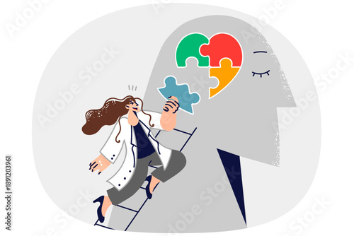 Woman psychotherapist helps restore psychological health of patient by assembling heart from puzzle