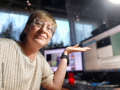 Canvas-taulu Woman enjoys her daily routine while working from home at a cozy desk setup with