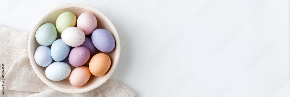 Obraz premium Bowl of colorful eggs is on a white background