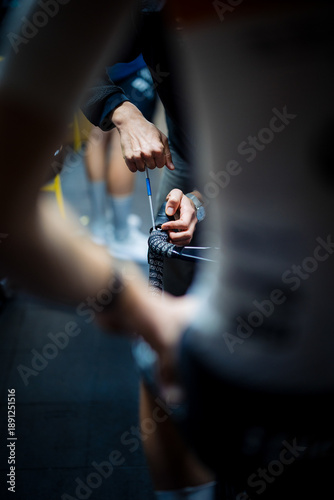 Mechanic hand adjusting bicycle brake lever in workshop