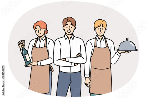 Restaurant waiters and administrators are ready to serve guests, want to have lunch or dinner. Male manager of cafe or lounge bar trains waiters to work in catering and horeca industry