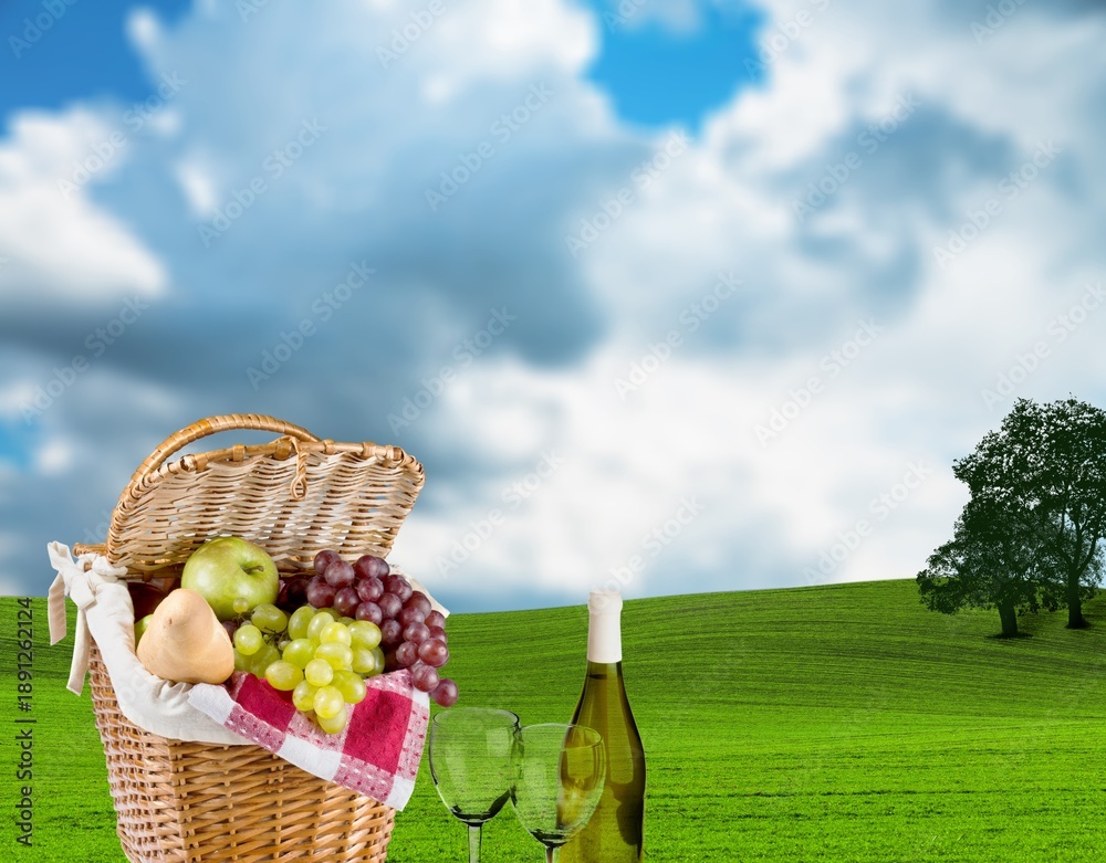 Obraz premium Beautiful cute picnic set on green grass in park