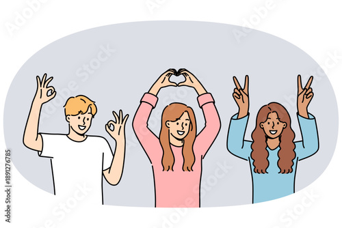Multiethnic people students smiling showing approval gestures and raising hands up. Happy guy and two students girls rejoice at having multiracial friends and lack of discrimination in society