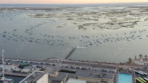 Boats anchored at Faro pier in Ria Formosa natural park aerial shot
