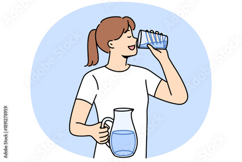 Woman drinks clean water from glass to refresh herself and saturate body with mineral aqua with vitamins. Girl with jug of water in hands, taking care of health, trying to avoid dehydration