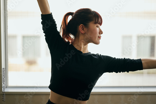 Canvas Print Young Woman Practicing Jazz Dance at Home by the Window