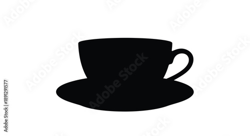 A black teacup and saucer rest on a surface a stark silhouette
