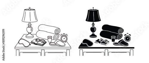 Bedside Table Setup with Lamp Books and Towels in Black and White