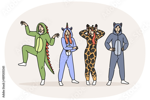 Pajama party for men and women in cute animal costumes for comfortable, restful sleep. Positive guys and girls prepared for masquerade on theme of pajama party, posing smiling in full length