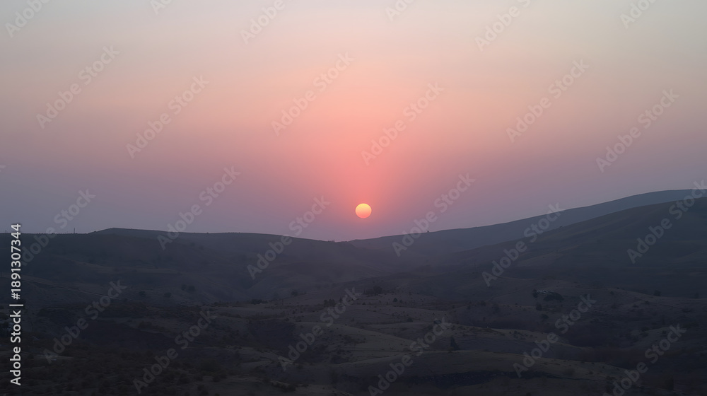 Obraz premium Crimson Horizon: A breathtaking vista unfolds as the sun dips below the horizon, painting the sky with a cascade of fiery hues and a tranquil desert scene.