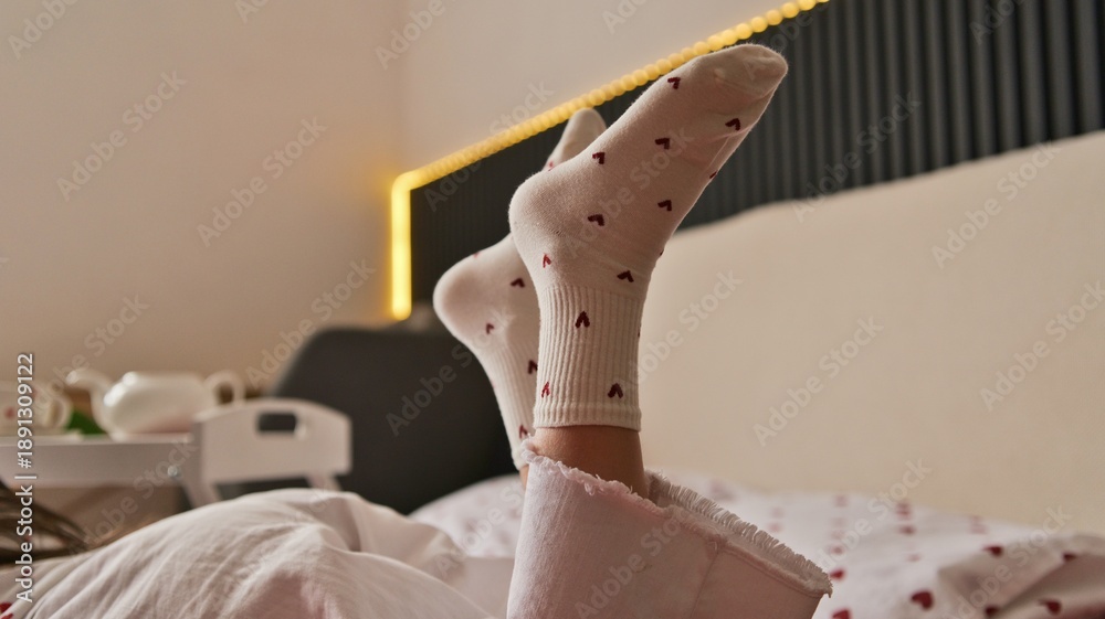 Αυτοκόλλητο Cozy morning in bed with heart patterned socks and slippers, feeling relaxed