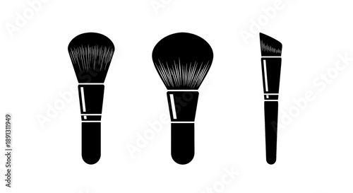 Three black makeup brushes with white accents on handles for beauty and cosmetics applications