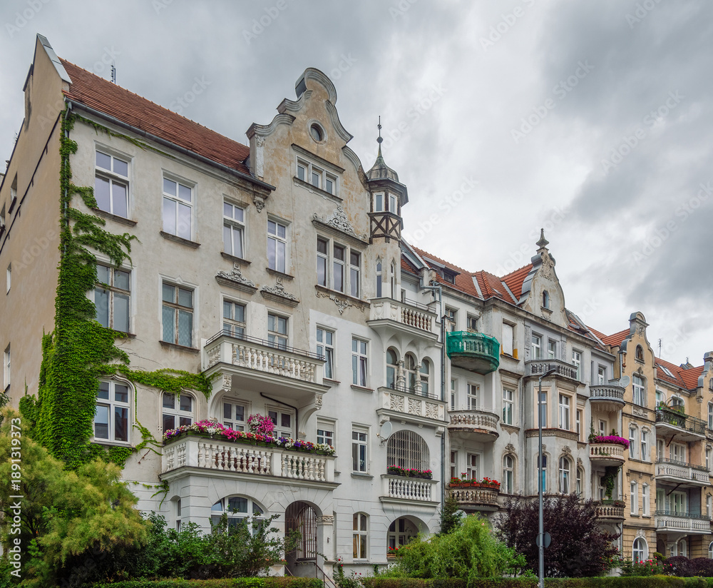 Fototapeta premium Elegant pre-war architecture of Wrocław, Poland, a city known for its diverse and beautifully preserved historic buildings. Grand, off-white facade featuring a mix of Art Nouveau and eclectic styles 