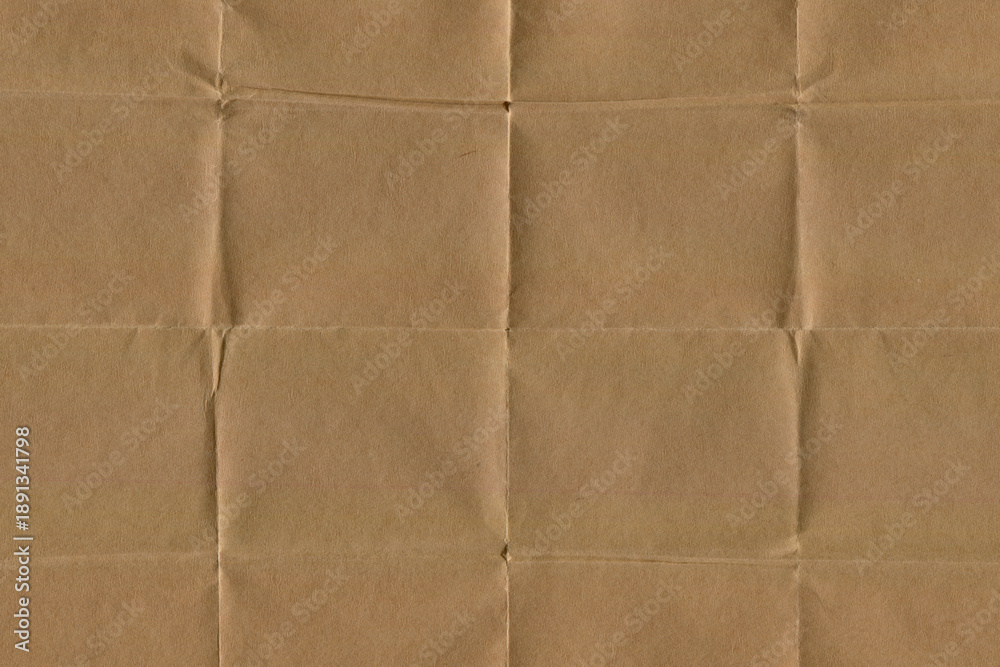 Fototapeta premium Brown Folded Paper Texture with subtle wrinkles and horizontal creases. Vintage Crumpled paper Background