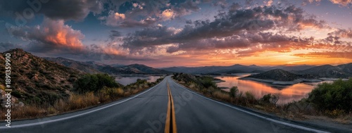 Scenic highway at sunset over a lake