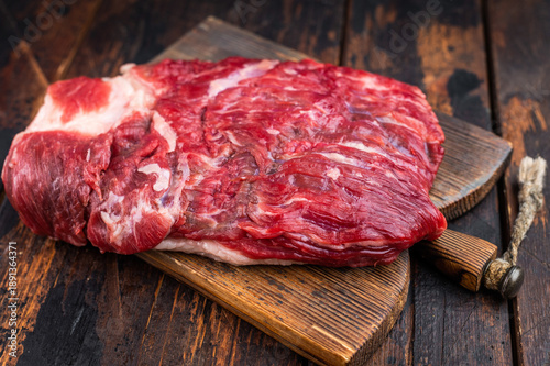 Canvastavla Raw beef brisket with cleaver on rustic wooden table, top view with copy space,